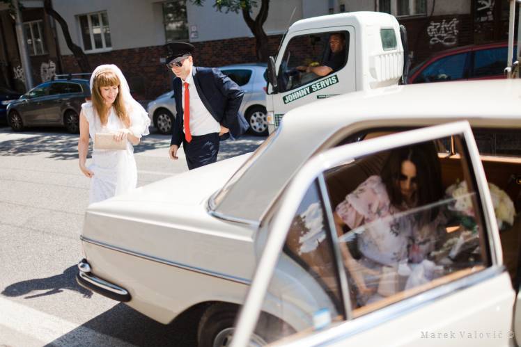 bride get out of wedding car on the street