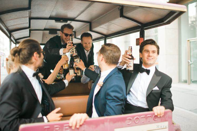 groom and bestman in the small city train drinking beer