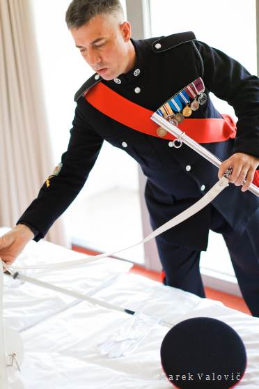groom getting ready, black english soldier uniform - sword