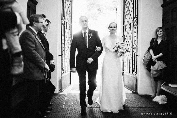 bride with father entering church for wedding ceremony