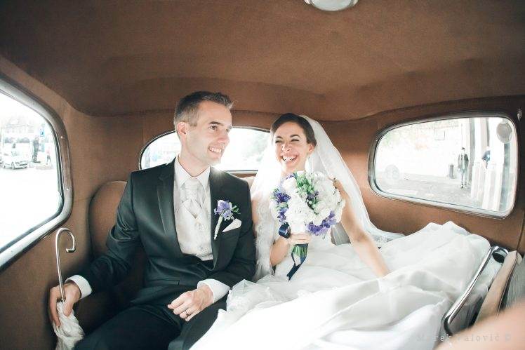 bride and groom in vintage car newlyweds